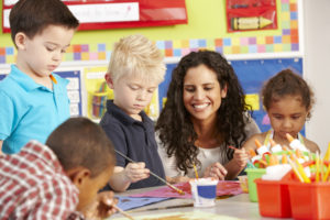 Elementary Age Schoolchildren In Art Class With Teacher