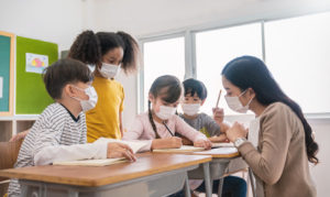 Portrait of students teacher wearing face mask in group study, self-protect from corona virus after lockdown. New normal, back to school concept