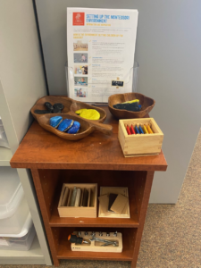 a wooden shelf with Montessori materials